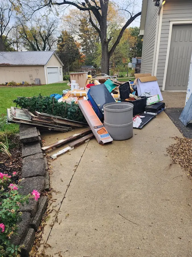 Dumpster being loaded with debris for Estate Cleanout Dumpster Rental in Wellfleet